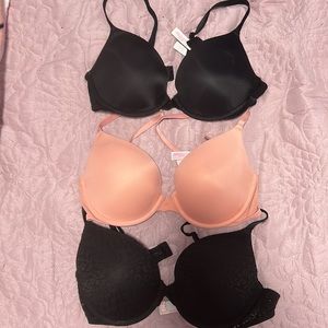Three VS Pink push-up bras (black, pink, and black lace)